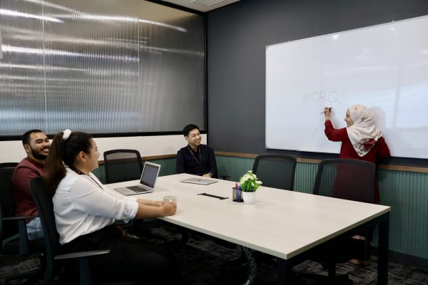 four people discussing in a meeting room
