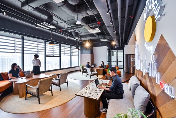 Modern coworking space in KL Sentral with professionals working at shared coworking area in the background.
