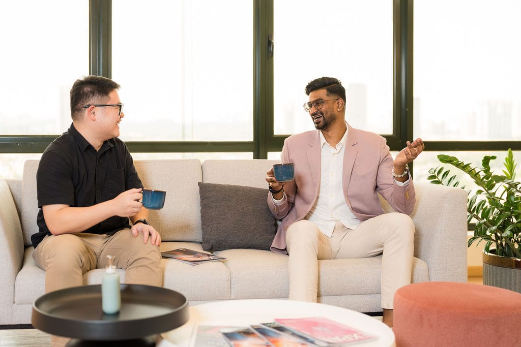 WORQ members talking over coffee in a coworking lounge at Bandar Utama